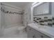 Updated bathroom with gray vanity, tub, and decorative tile at 2441 Persian Dr # 61, Clearwater, FL 33763