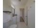 Well-lit bathroom with a tiled floor, modern fixtures, and easy access to bedroom at 2441 Persian Dr # 61, Clearwater, FL 33763