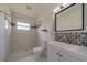 Updated bathroom features a walk-in shower and modern vanity at 2441 Persian Dr # 61, Clearwater, FL 33763