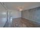 Spacious bedroom with hardwood floors, ceiling fan, and a modern accent wall at 2441 Persian Dr # 61, Clearwater, FL 33763
