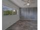 This bedroom features gray wood-look floors, a ceiling fan, and a dark accent wall at 2441 Persian Dr # 61, Clearwater, FL 33763