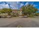 Exterior of complex featuring ample parking and well maintained landscaping at 2441 Persian Dr # 61, Clearwater, FL 33763