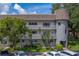 Exterior of complex featuring ample parking and well maintained landscaping at 2441 Persian Dr # 61, Clearwater, FL 33763