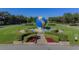Landscaped community entrance featuring a large globe on display in a fountain at 2441 Persian Dr # 61, Clearwater, FL 33763