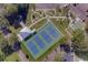 Aerial view of four well-maintained tennis courts with a covered viewing area at 2441 Persian Dr # 61, Clearwater, FL 33763
