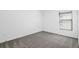 Cozy bedroom with soft carpet, a window with blinds, and neutral paint scheme at 2464 Fairview Ln, Spring Hill, FL 34609