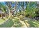 The backyard offers lots of space and mature trees at 2503 Victarra Cir, Lutz, FL 33559