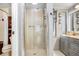 Ensuite bathroom with glass shower enclosure and modern vanity at 2503 Victarra Cir, Lutz, FL 33559