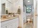 Bathroom with white vanity, marble countertop, and a separate shower area with a toilet at 2503 Victarra Cir, Lutz, FL 33559