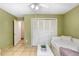 Bedroom featuring a ceiling fan and closet along with a view into a nearby tiled room at 2503 Victarra Cir, Lutz, FL 33559