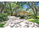 Charming home with well-manicured lawn, mature trees, and a spacious driveway leading to a two-car garage at 2503 Victarra Cir, Lutz, FL 33559