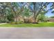 Charming single-story home featuring a lush front yard and mature trees at 2503 Victarra Cir, Lutz, FL 33559