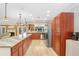 Large kitchen with stainless steel appliances, custom wood cabinetry, and eat-in island at 2503 Victarra Cir, Lutz, FL 33559