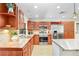 Bright kitchen with stainless steel appliances, wood cabinets, and decorative tile backsplash at 2503 Victarra Cir, Lutz, FL 33559