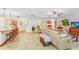 Spacious living area with tile flooring, open to the kitchen, with bar seating and lots of space at 2503 Victarra Cir, Lutz, FL 33559
