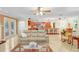 Bright living room open to the kitchen featuring tile flooring, bar seating, and updated appliances at 2503 Victarra Cir, Lutz, FL 33559