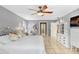 Bright bedroom with ceiling fan, tiled floors and ensuite bathroom at 2503 Victarra Cir, Lutz, FL 33559