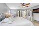 Large bedroom with ceiling fan, tiled floors and ensuite bathroom at 2503 Victarra Cir, Lutz, FL 33559