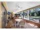 A screened patio overlooking a pool area with lots of seating and entertaining space at 2503 Victarra Cir, Lutz, FL 33559