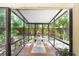 A screened patio with nice furniture and plants with an outdoor garden view at 2503 Victarra Cir, Lutz, FL 33559