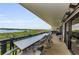 Expansive balcony with outdoor bar overlooking lush greenery and serene waterfront views at 2700 Bayshore Blvd # 11405, Dunedin, FL 34698
