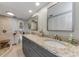 Bathroom with double sinks, granite countertop, decorative accessories and walk-in shower at 2700 Bayshore Blvd # 11405, Dunedin, FL 34698