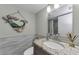 Bathroom with single sink, granite countertop, mermaid decor and textured wall at 2700 Bayshore Blvd # 11405, Dunedin, FL 34698