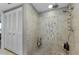 Nicely renovated walk-in shower with custom tile and shelving for storage at 2700 Bayshore Blvd # 11405, Dunedin, FL 34698