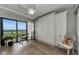 Bedroom with built-in storage, murphy bed, hardwood floors, ceiling fan and balcony access at 2700 Bayshore Blvd # 11405, Dunedin, FL 34698