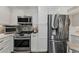 Well-equipped kitchen featuring stainless steel appliances, granite countertops and white cabinetry at 2700 Bayshore Blvd # 11405, Dunedin, FL 34698