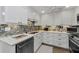 Modern kitchen with white cabinets, stylish backsplash, and stainless-steel appliances at 2700 Bayshore Blvd # 11405, Dunedin, FL 34698