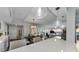 Open living and dining room showcasing a large kitchen island with pendant lighting at 2700 Bayshore Blvd # 11405, Dunedin, FL 34698
