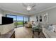 Bright living room featuring hardwood floors, a large sliding glass door, and a beautiful water view at 2700 Bayshore Blvd # 11405, Dunedin, FL 34698