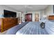 Bright main bedroom with hardwood floors, french doors, and a decorative closet at 2700 Bayshore Blvd # 11405, Dunedin, FL 34698