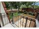 Balcony with fenced outdoor space surrounded by mature trees at 2725 11Th Ct, Palm Harbor, FL 34684