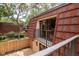 This is an exterior image of a balcony with a view of a fenced-in yard and lush trees at 2725 11Th Ct, Palm Harbor, FL 34684