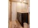 Bathroom featuring a dark vanity with lighter countertop, walk-in shower, and light tile floor at 2725 11Th Ct, Palm Harbor, FL 34684