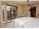 Comfortable bedroom with sliding door to a balcony, neutral walls and carpeted floor at 2725 11Th Ct, Palm Harbor, FL 34684