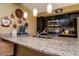 Beautiful kitchen featuring granite counters, stainless steel appliances and modern hanging lights at 2725 11Th Ct, Palm Harbor, FL 34684