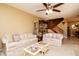 Inviting living room with plush sofas, staircase, and neutral color palette at 2725 11Th Ct, Palm Harbor, FL 34684