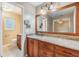 Bathroom featuring a large mirror, vanity, and sink with granite countertops at 2911 Pemberton Creek Dr, Seffner, FL 33584
