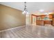 Open-concept dining area with chandelier lighting, connected to a kitchen with wooden cabinetry at 2911 Pemberton Creek Dr, Seffner, FL 33584