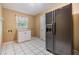 Small kitchen with a large refrigerator and window over a sink at 2911 Pemberton Creek Dr, Seffner, FL 33584