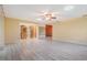 Bright living room featuring wood flooring, a ceiling fan, and sliding glass doors at 2911 Pemberton Creek Dr, Seffner, FL 33584
