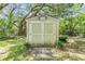 Well-maintained storage shed with double doors in a lush, green yard at 2911 Pemberton Creek Dr, Seffner, FL 33584