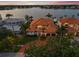 Stunning waterfront home with lush landscaping, tile roof, and circular driveway at 301 Bayview Ne Dr, St Petersburg, FL 33704
