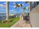 Backyard with a grill and outdoor patio, beautiful waterfront view, and a private boat dock at 301 Bayview Ne Dr, St Petersburg, FL 33704