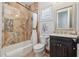 Elegant bathroom featuring marble tile, a shower-tub combo, and modern fixtures under soft natural light at 301 Bayview Ne Dr, St Petersburg, FL 33704