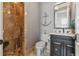 A cozy half-bath featuring unique nautical decor, a corner shower, and stylish fixtures at 301 Bayview Ne Dr, St Petersburg, FL 33704