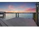 Waterfront home featuring a dock with beautiful sunset views at 301 Bayview Ne Dr, St Petersburg, FL 33704